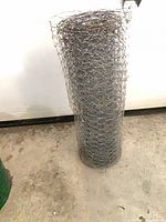 Full view of rolled chicken wire standing upright