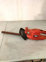 Full view of Black & Decker corded hedge trimmer showing body, handle and blade