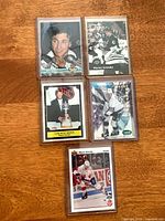 Group of five Wayne Gretzky cards in sleeves