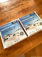 Two sealed HealthGuard Premium Terry pillow protector packages