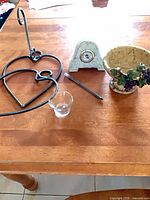 All three items on table: mantel clock, metal heart sconce with glass cup, compote bowl