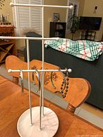 Full view of jewelry stand holding bangles and bead bracelet