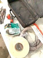 Overview of bag, hose, tape, sealed compound bag