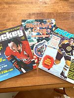 Three hockey magazines laid out on table showing front covers