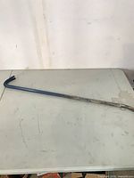 Full view of 36" blue steel pry bar on table