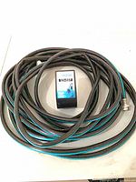 Coiled black hose with holder in center