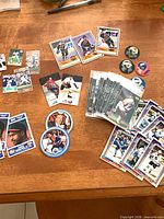 Overview of assorted promotional sports cards and discs on table