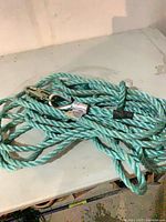 Coiled green lifeline rope on surface