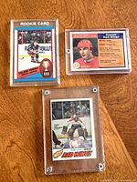 Group shot of three O-Pee-Chee hockey cards in acrylic holders