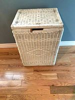 Rectangular white wicker laundry hamper with lid