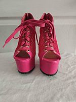 Front view of both shoes showing lace-up fronts, peep toes and platforms