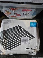 Box displaying Broil King cast iron cooking grid with label
