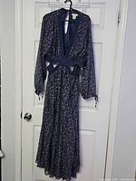 Full front view of navy floral Festi dress on hanger