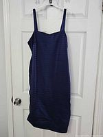 Full view of navy ribbed bodycon dress on hanger