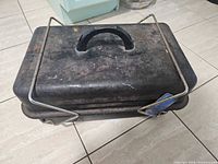 Closed Sunbeam grill showing lid, handle and exterior wear