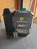 Front view of Yardworks 3.0 Ah 48 V battery showing labels and condition