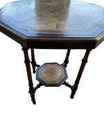 Full view of the octagonal table showing shape, legs and lower shelf