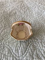 Interior view of octagonal porcelain trinket dish showing hand-painted floral motif and gilded rim