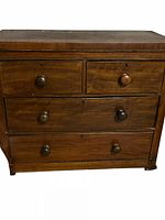 Front view showing four drawers, knobs, keyholes