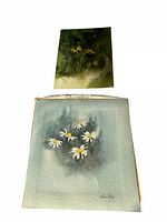 Two unframed watercolour paintings of daisies on textured paper