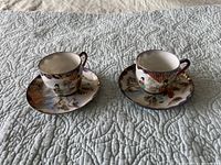Both teacups on saucers showing size and decoration