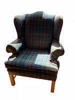 Front view of plaid wingback armchair showing upholstery pattern, shape and wooden legs