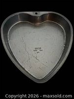 Interior of Ekco heart-shaped cake pan showing brand mark and surface wear