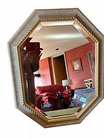 Octagonal wall mirror with textured wood frame and gold trim