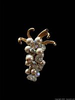 Gold-tone brooch with cascading pearls and aurora borealis crystals