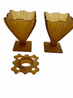 Two amber pressed glass vases and matching flower frog displayed on white background