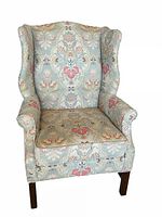 Front view of one mahogany Chippendale wingback chair showing upholstery pattern and frame