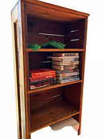 Angled full view of pine bookcase showing shelves and overall structure