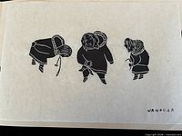 Close view of signed stonecut print showing three Inuit figures