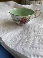Mint-green interior floral teacup with gold trim