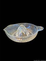Clear ribbed glass citrus reamer in integrated bowl