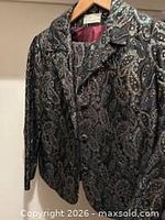 full view of jacket on hanger showing fabric, lining and label