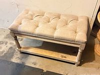 Oblique view of top and frame showing tufted seat and shelf