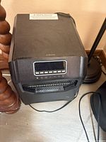 Front view showing digital display, controls and grille