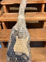Guitar wrapped in bubble wrap showing blue body and white pickguard