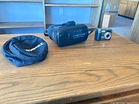 Overall view of VR headset, camera and pouch on table