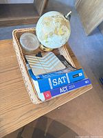 Tray contents showing globe, books, jar, coaster