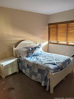 Bed frame fully assembled with mattress, quilt, pillows and nightstand