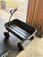 Full view of Gorilla Carts wagon showing black poly body, pull handle, four wheels