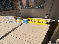 Both ladders laid flat showing overall condition and materials