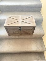 Closed trunk on stairs showing exterior panels and finish