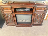 Front view showing entire console with cabinets, open shelf, fireplace insert