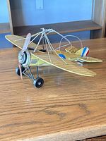 Full view of metal biplane model on tabletop