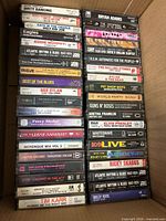 Box of three columns of cassette tapes showing titles and artists
