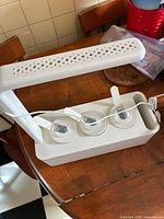 Smart Garden 3 assembled showing LED arm, three pod openings and power cord