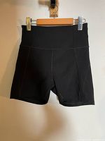 Front view of black Girlfriend Collective high-rise shorts